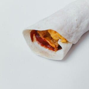 A BREAKFAST WRAP WITH PEANUT BUTTER AND STRAWBERRY JAM