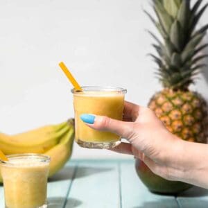 Woman holding a pineapple smoothie