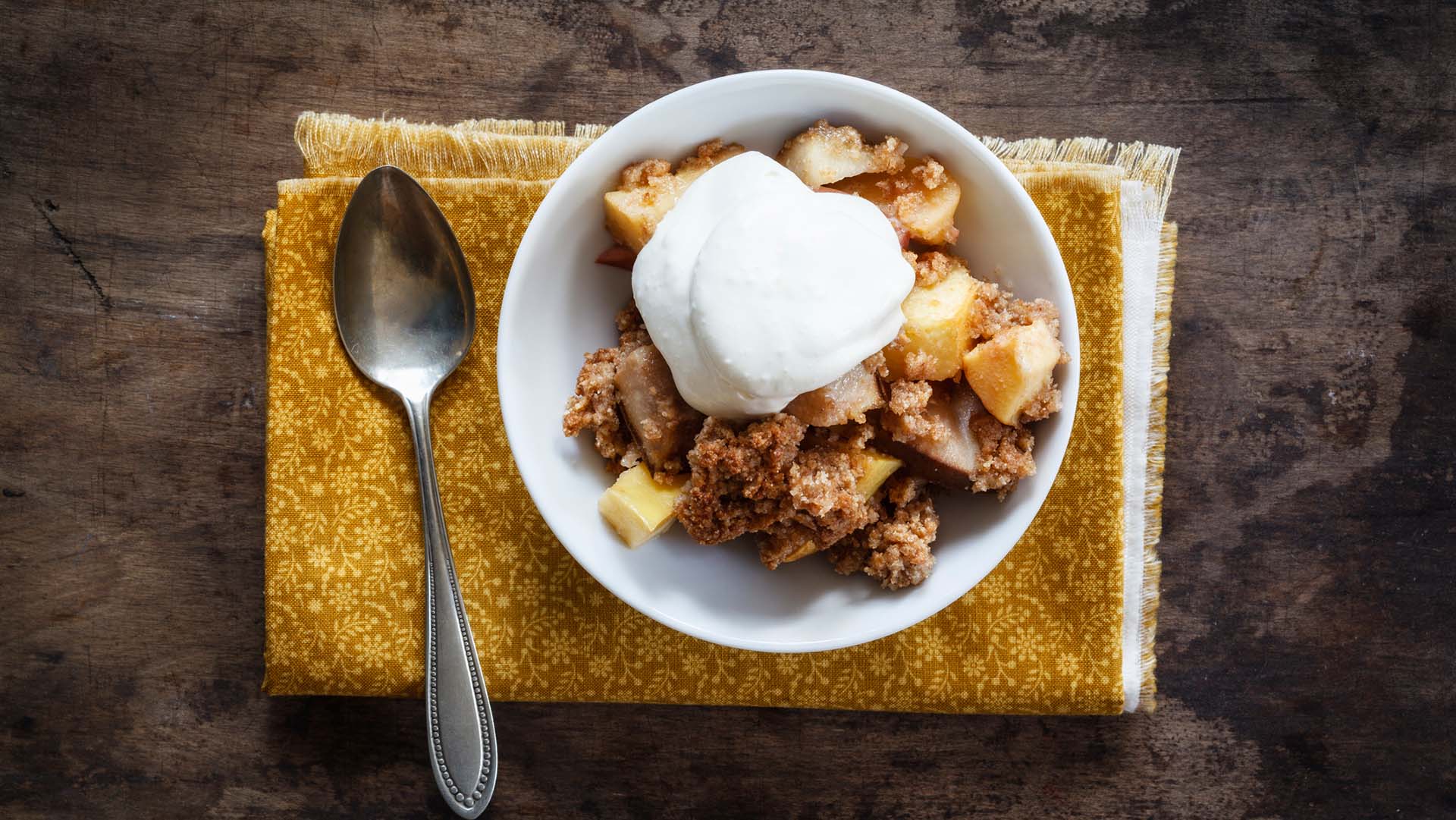 Healthy Apple Crumble Recipe apple crumble in a bowl with fresh yoghurt