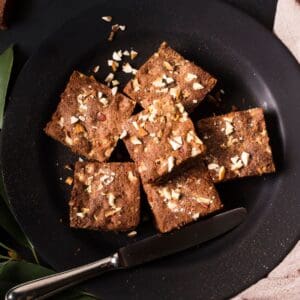 Chocolate fudge squares served on a black plate