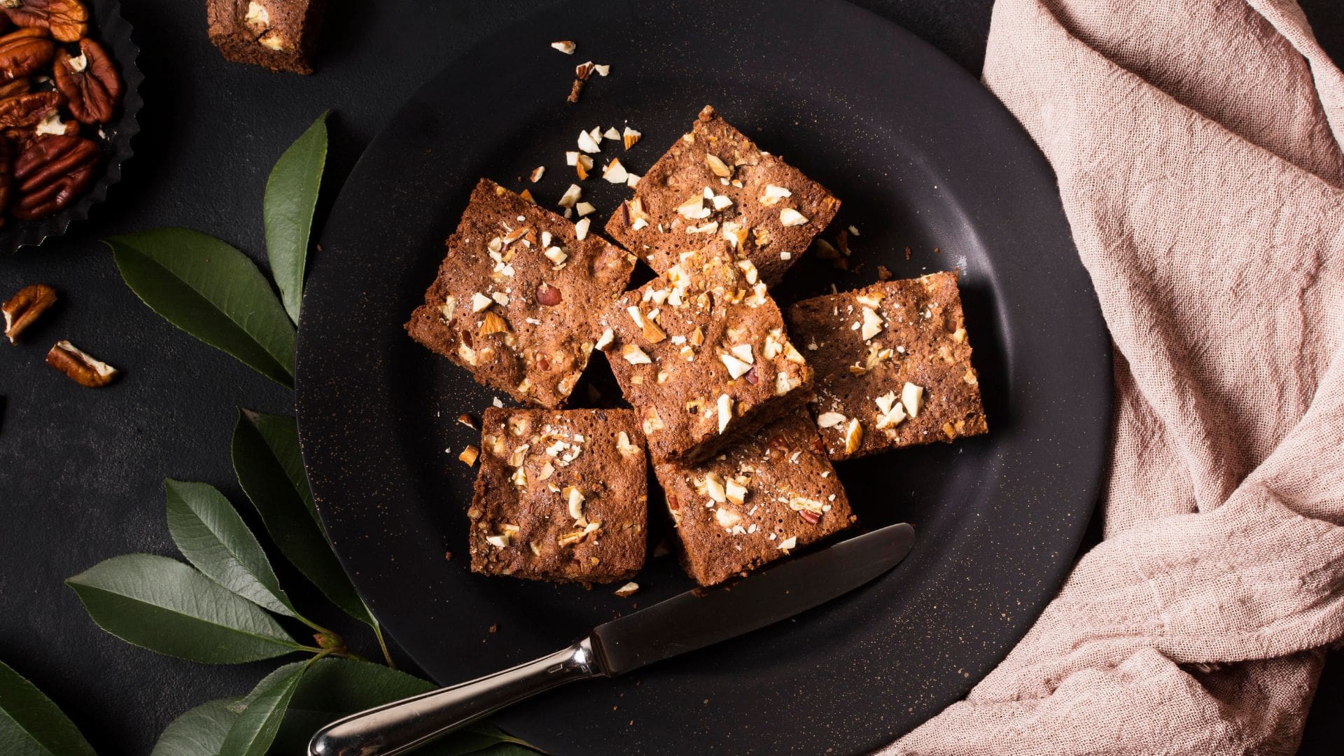 Chocolate fudge squares served on a black plate
