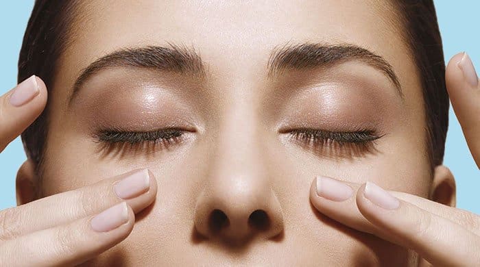 Woman touching her blackhead