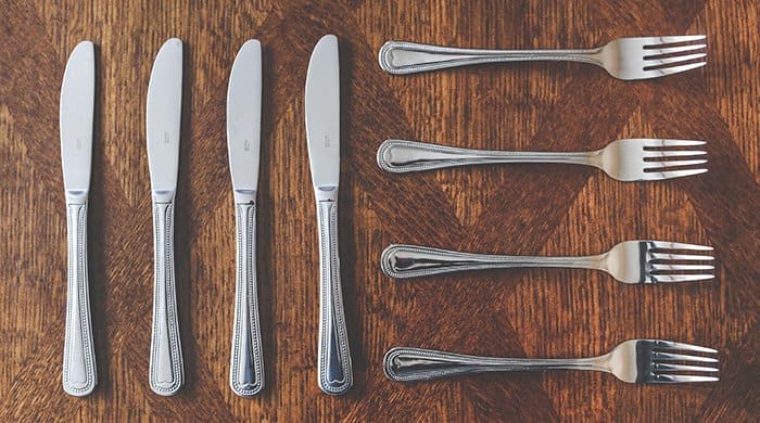 Knives and forks ready lined up for a meal