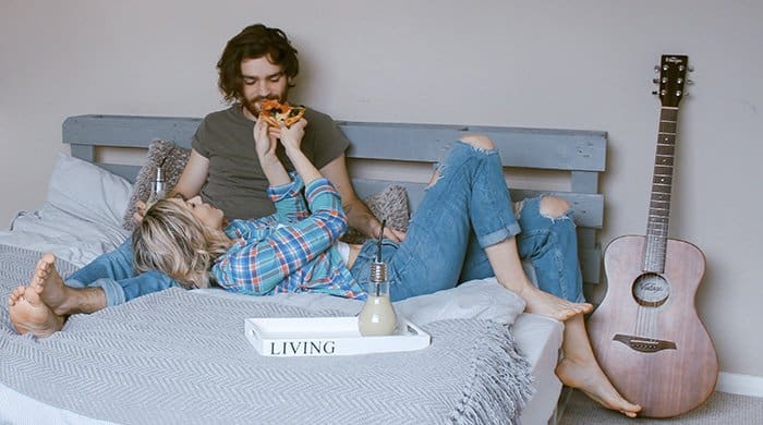 a woman lying on a bed with her boyfriend