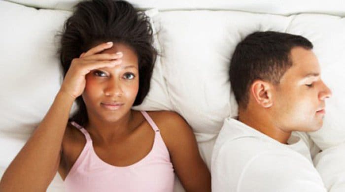 a couple in bed after they've had sex