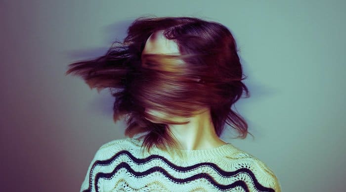 An image of a woman flicking her hair to represent a toxic person