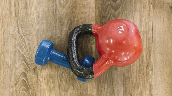 A weight and kettlebell on a wooden floor