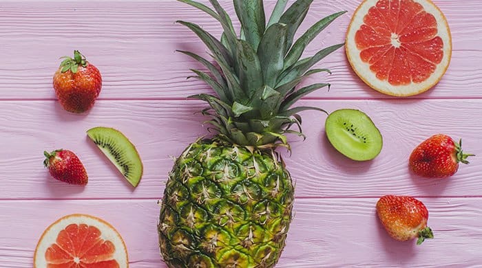 low-carb fruits on a pink background