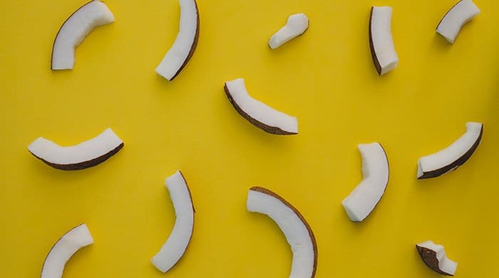 Coconut Coconut pieces on a yellow background