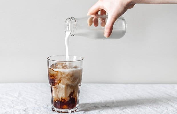 Woman pouring an iced coffee