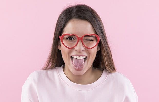 a woman sticking out her tongue to show her taste buds