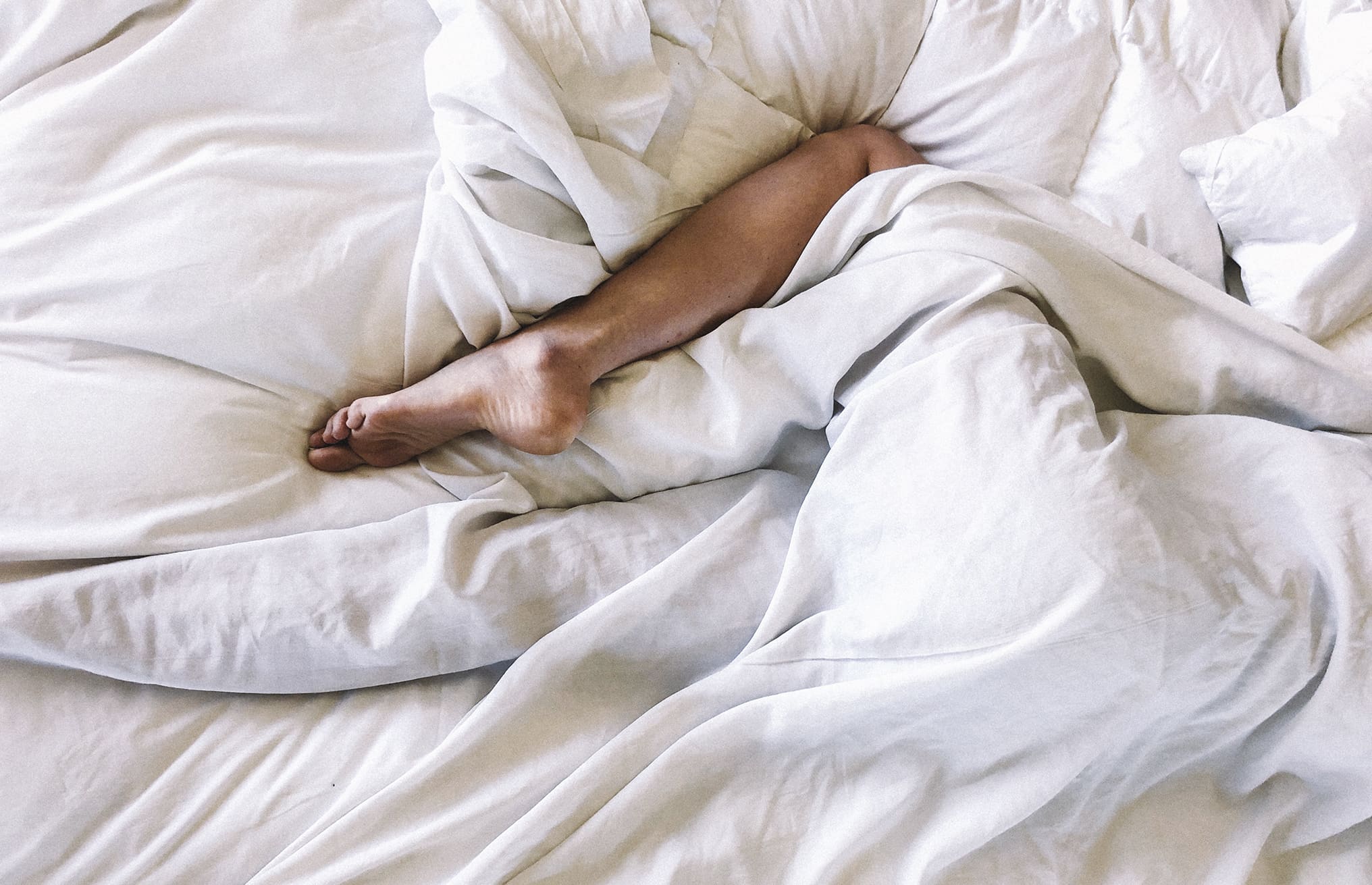 a woman in bed having a sex dream