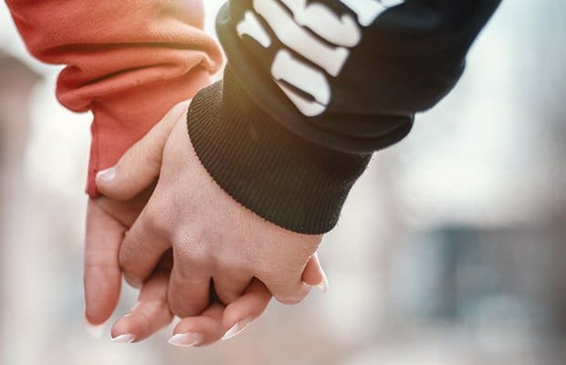 Controlling-Boyfriend a woman holing hands with her controlling boyfriend