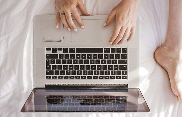 a woman and her partner watching porn together on a laptop