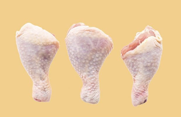 raw chicken meat against orange background