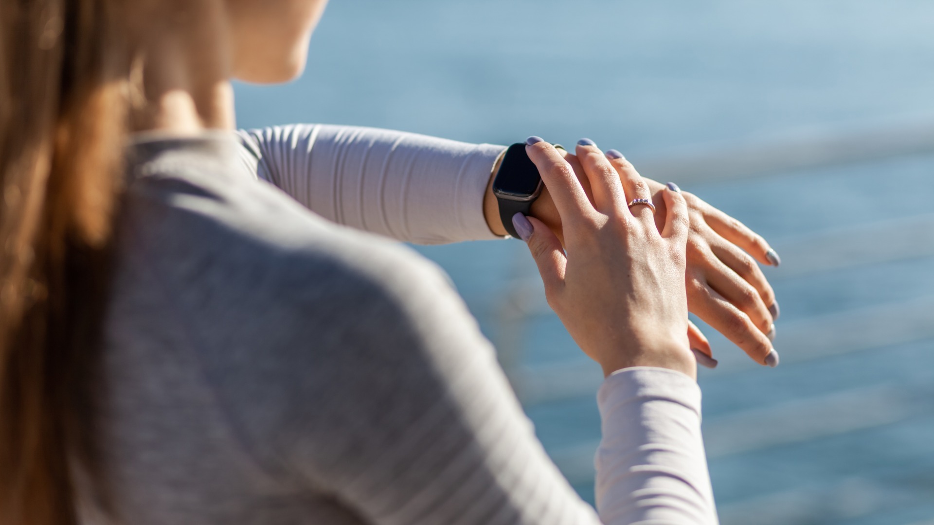 Woman wearing health wearable checking her smartwatch