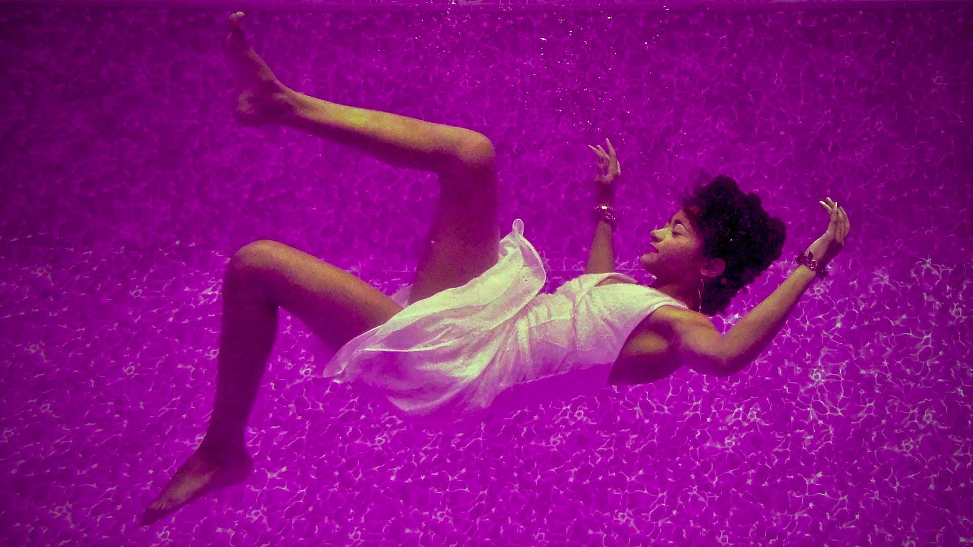 woman floating, dreaming or sleeping under water