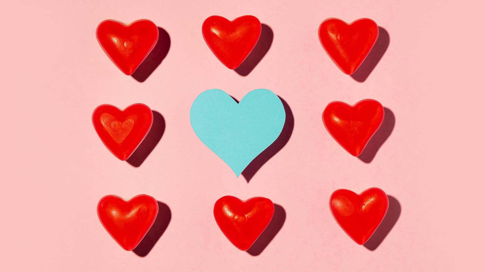 Red and blue hearts on pink background
