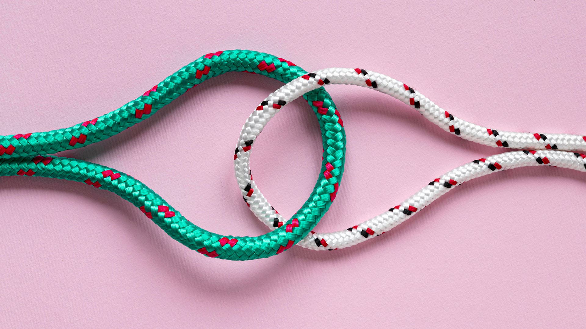Nautical green and white rope knots on pink background symbolising a soul tie