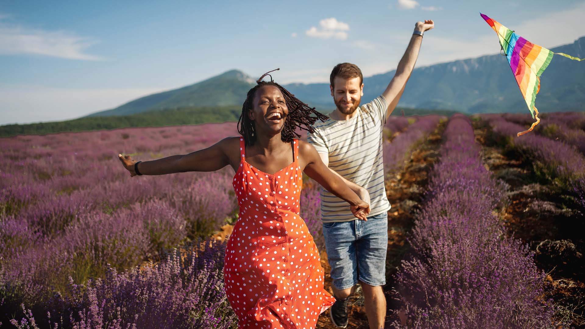Couple running and having fun in a lavender field
