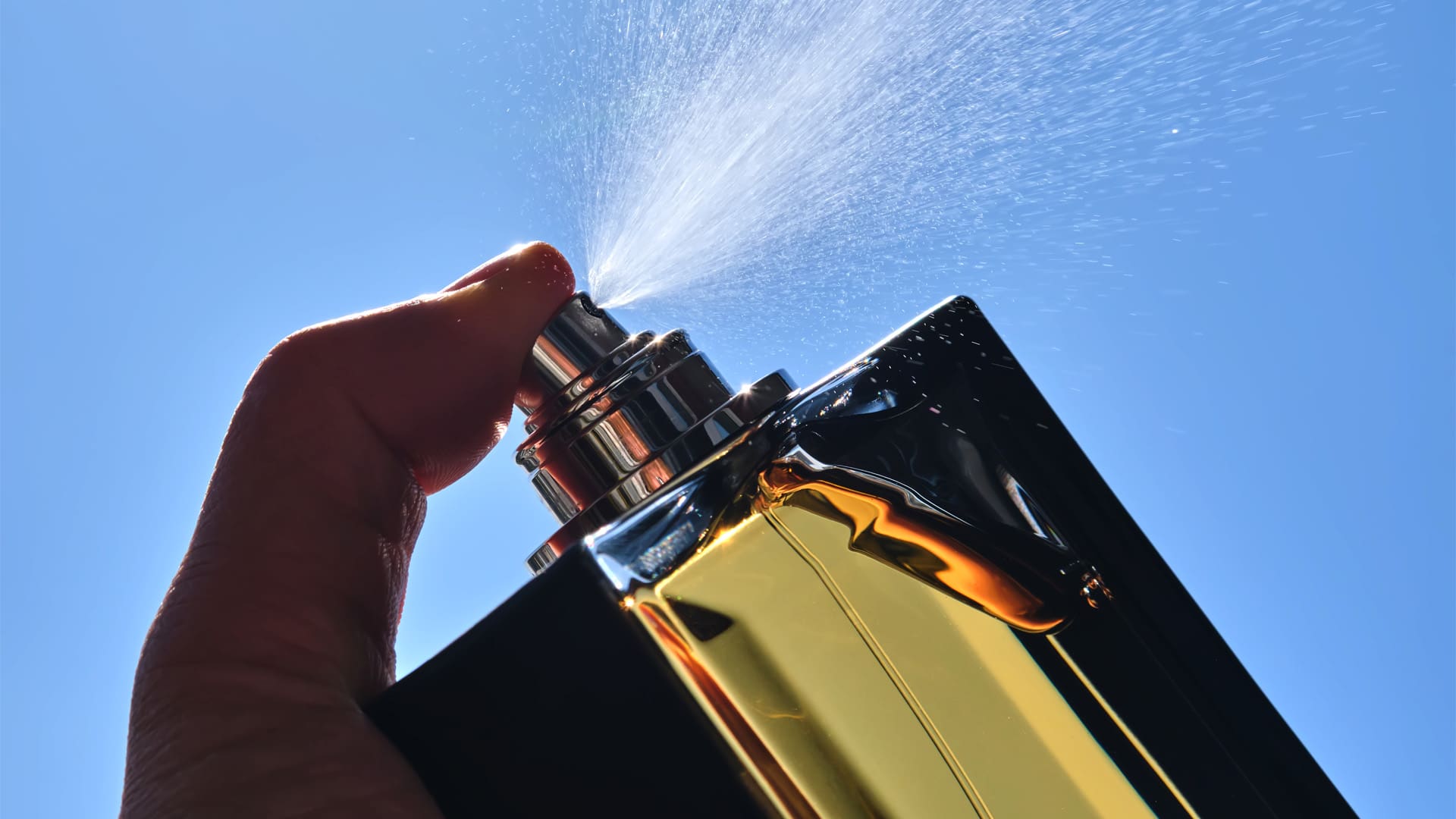 Spraying Perfume Against The Sky