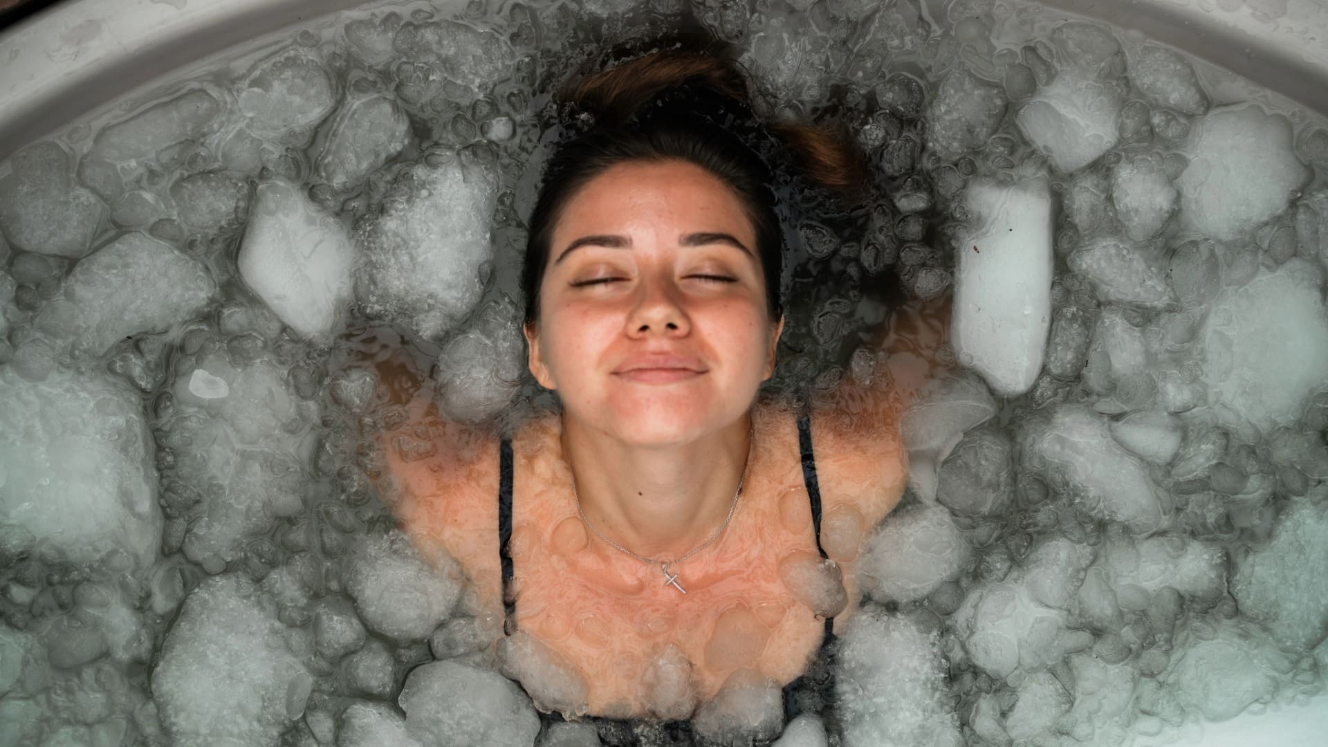 Woman in ice bath smiling