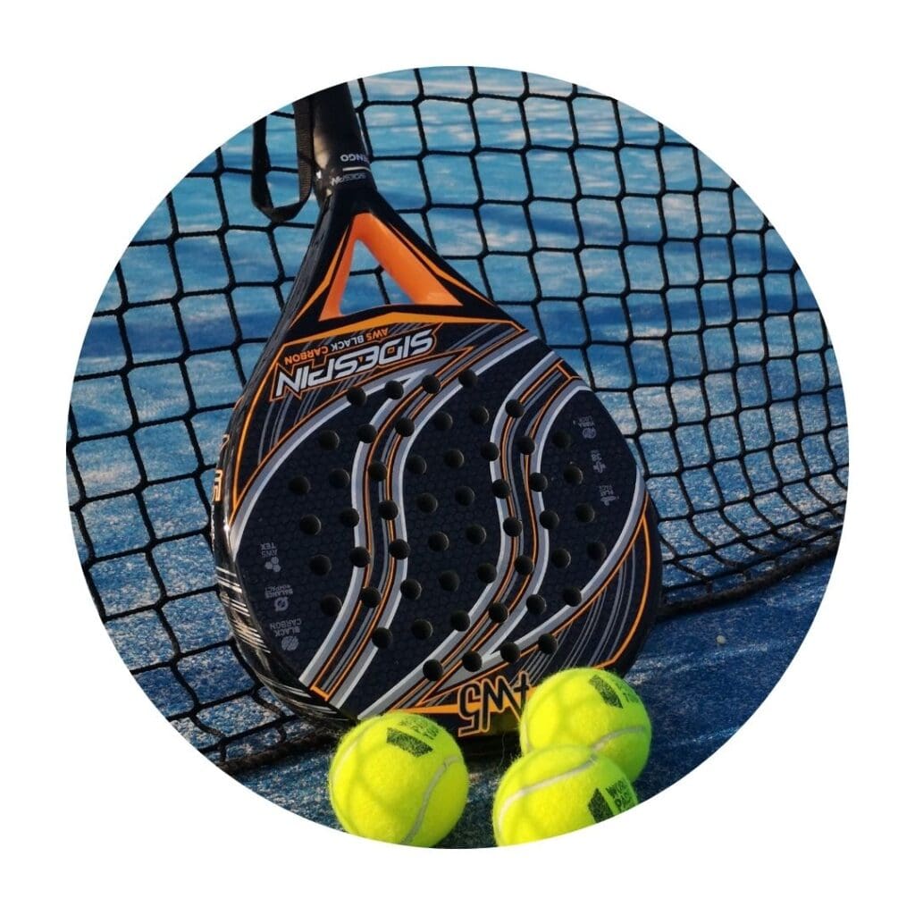 A padel racquet on the net with three tennis balls on blue padel court
