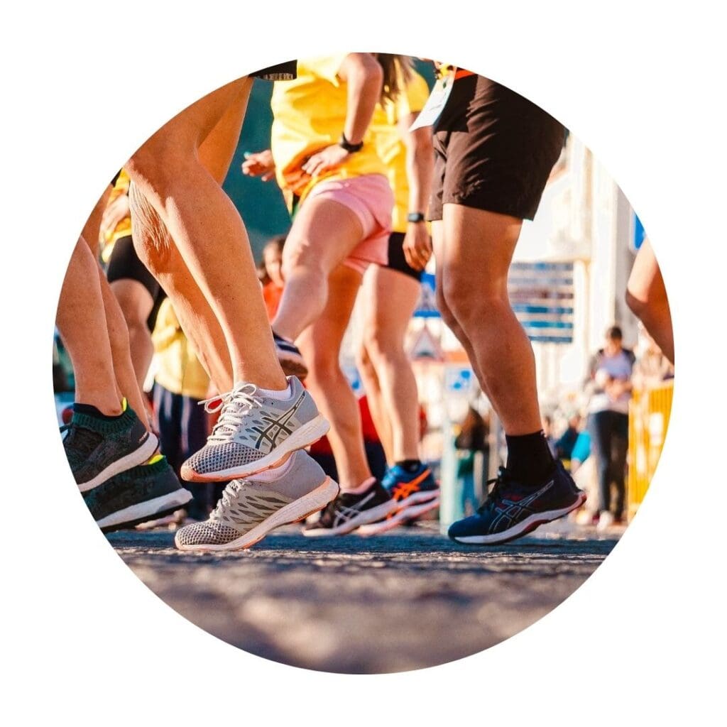 Close-up of the legs and feet of many people running wearing running shoes 