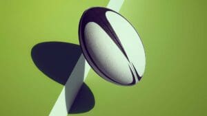 Rugby ball hopping off a green step