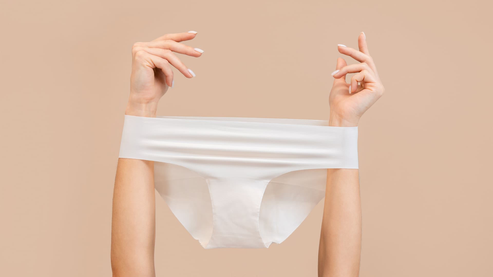 Woman with her hands in the air holding underwear