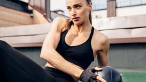 Fit woman doing a Russian twist on an exercise mat.