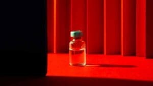 Vaccine vial on red background