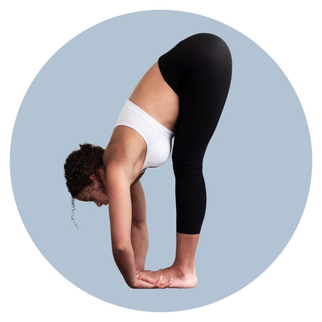 Woman doing Padahastasana (Hands-under-feet pose) yoga poses to beat burnout